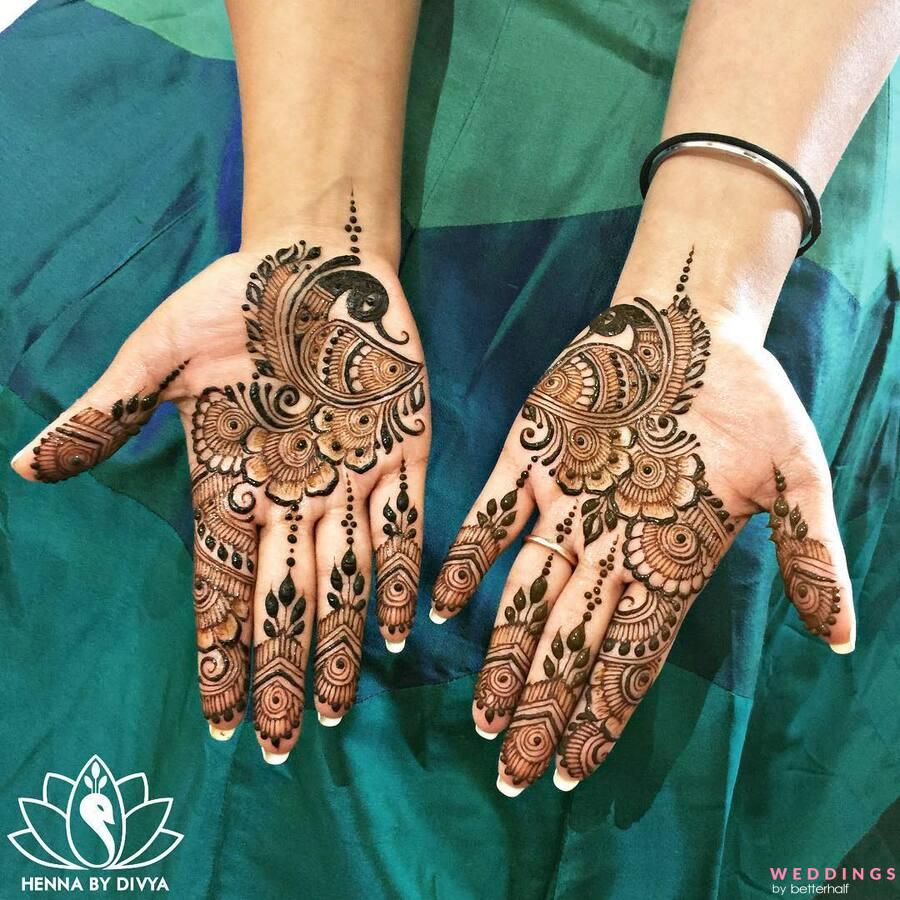 Woman with beautiful henna tattoo on hand against green background,  closeup. Traditional mehndi Stock Photo - Alamy