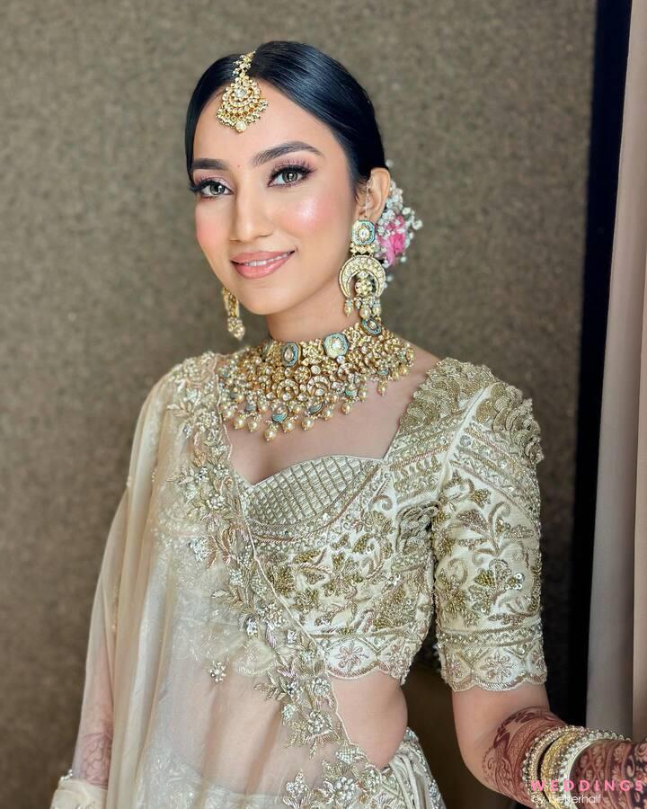 Photo of A bride in soft pink lehenga and subtle makeup