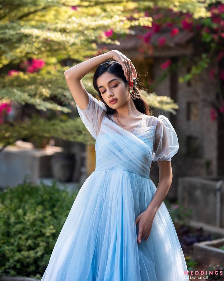 Elegant woman in blue ball gown dress standing and posing on a sunny evening  at city street. Fashion model full length portrait Stock Photo | Adobe Stock