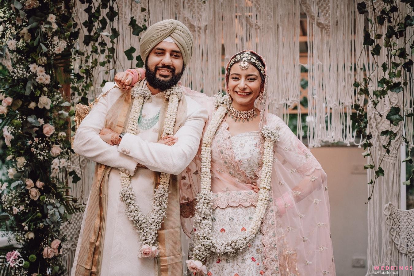 Photo of A sikh bride and groom pose after their wedding