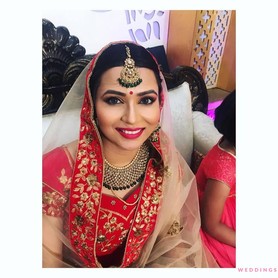 A Stunning Bride In Red Lehenga With Scalloped Edge Dupatta