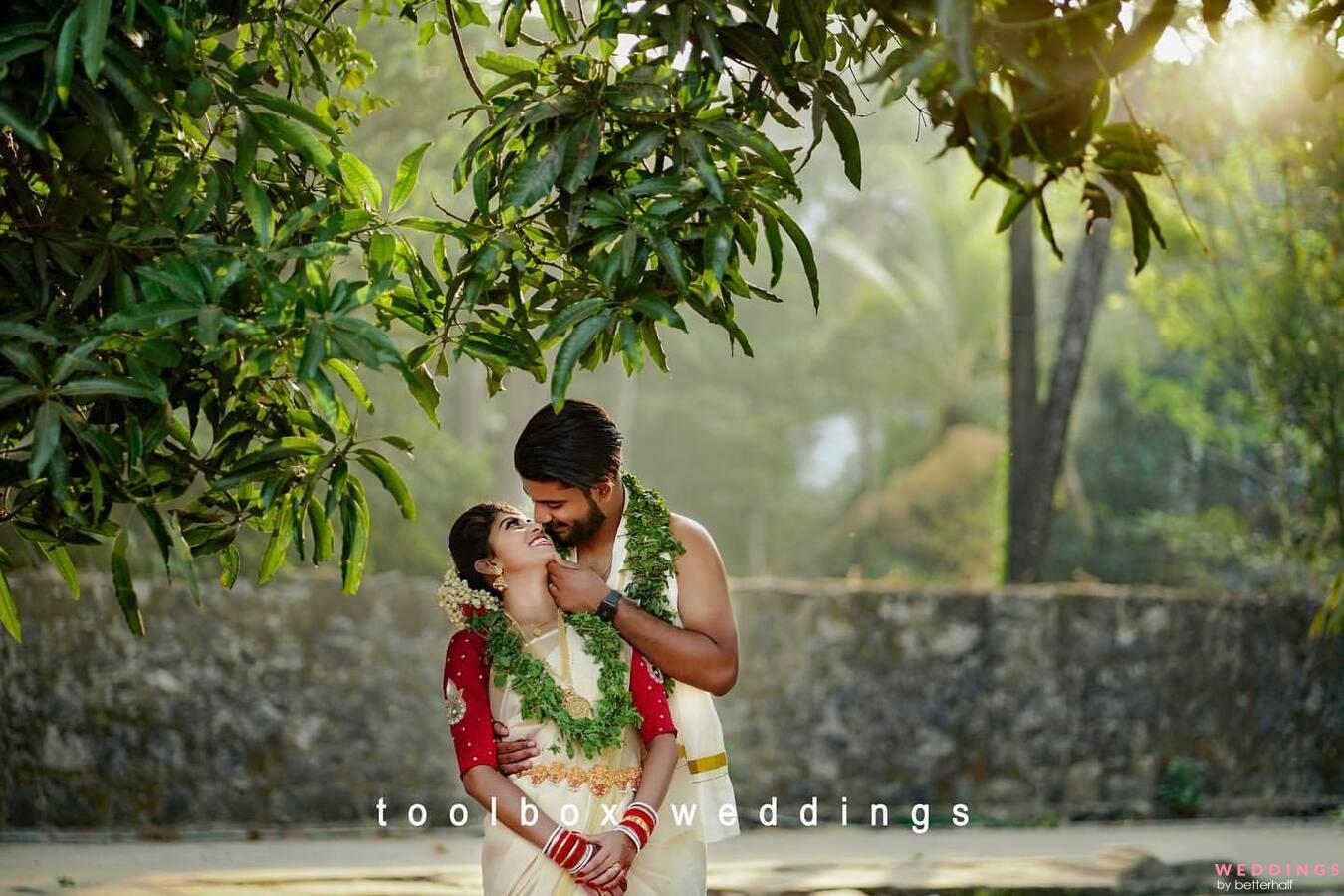Young Couple in White Clothes Pose Sideways in Arch of Trees in Forest.  Girl with Bouquet of Roses and Bare Shoulders Stock Photo - Image of bride,  smile: 267982772