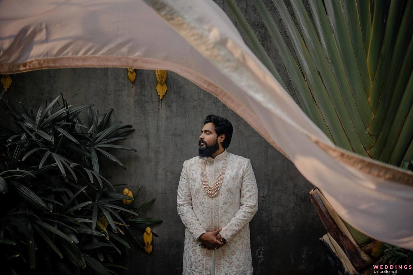 Indian groom wears ethnic or traditional cloths, Male fashion model with  dark blue sherwani, posing / standing against brown grunge background,  selective focus Stock Photo | Adobe Stock